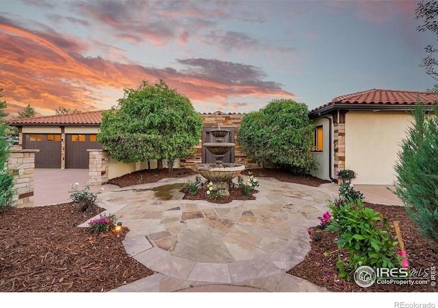 patio terrace at dusk with a garage