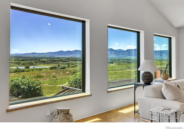 interior space featuring a water and mountain view and lofted ceiling