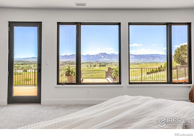 bedroom with a mountain view and carpet flooring