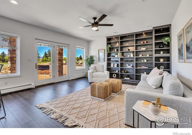 living room with hardwood / wood-style floors, ceiling fan, and a baseboard heating unit