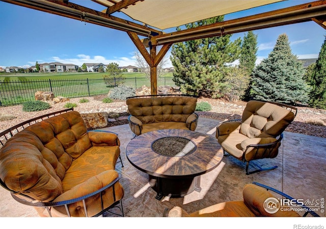 view of patio / terrace with an outdoor fire pit and a pergola