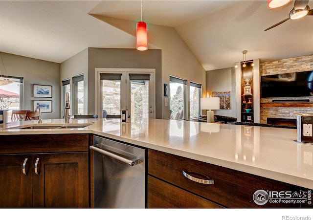 kitchen with vaulted ceiling, decorative light fixtures, stainless steel dishwasher, ceiling fan, and dark brown cabinetry