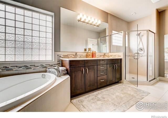 bathroom featuring vanity, plenty of natural light, independent shower and bath, and tile patterned floors