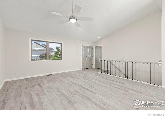 spare room with light hardwood / wood-style floors, ceiling fan, and vaulted ceiling