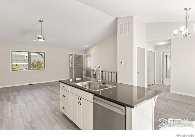 kitchen featuring sink, white cabinetry, vaulted ceiling, dishwasher, and an island with sink