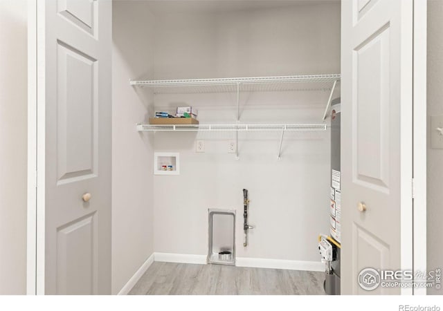 washroom with light hardwood / wood-style floors and hookup for a washing machine