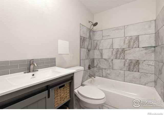 full bathroom with toilet, vanity, decorative backsplash, and tiled shower / bath combo