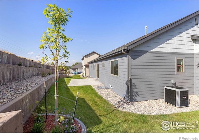 view of yard featuring cooling unit and a patio