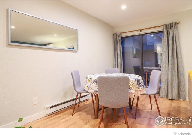 dining room featuring wood-type flooring and baseboard heating