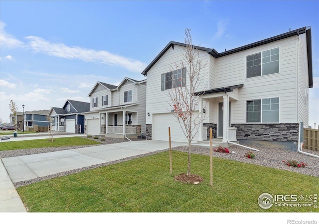 view of front of house with a garage and a front lawn