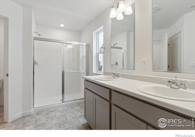 bathroom with toilet, vanity, and walk in shower