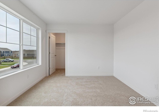 spare room featuring light colored carpet