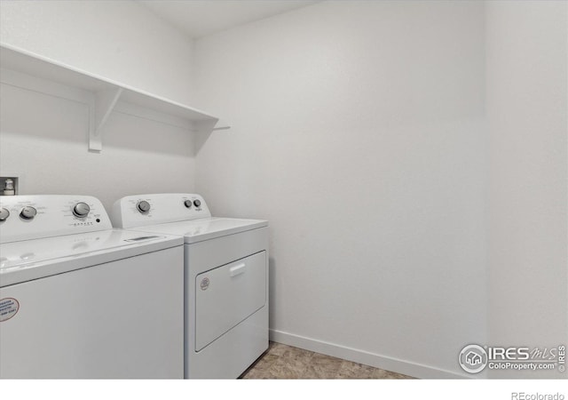 clothes washing area featuring washer and clothes dryer