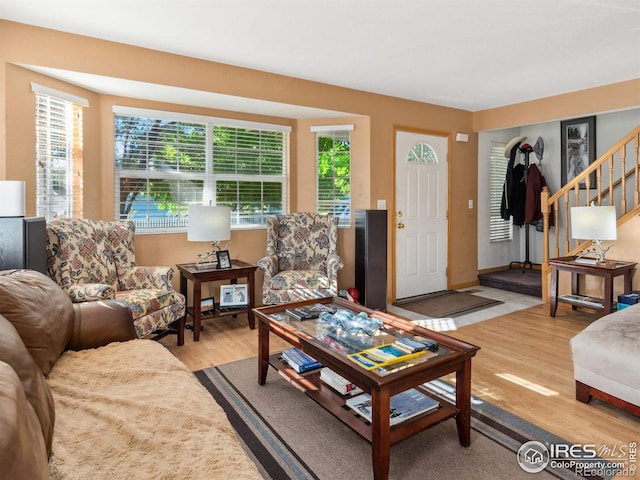 living room with light wood-type flooring and plenty of natural light