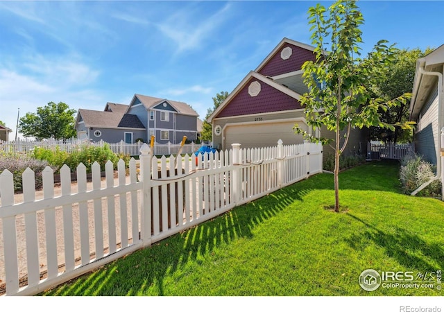 exterior space with a garage and a front lawn