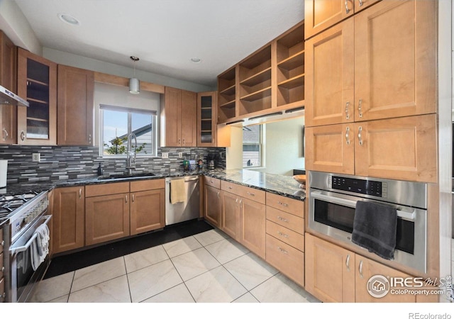 kitchen featuring dark stone counters, pendant lighting, light tile patterned floors, stainless steel appliances, and sink