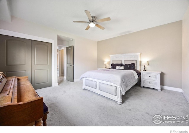 bedroom with a closet, ceiling fan, and light carpet