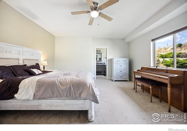 carpeted bedroom featuring ensuite bath and ceiling fan