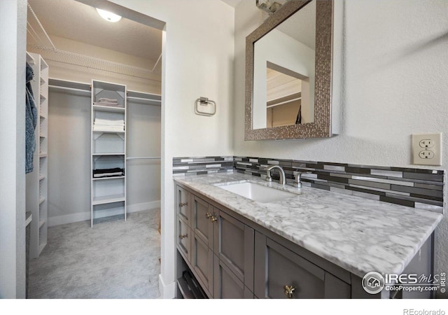 bathroom featuring tasteful backsplash and vanity