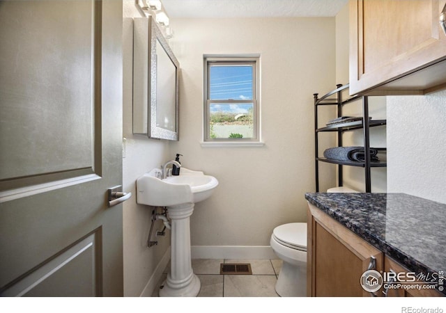 bathroom with tile patterned flooring and toilet