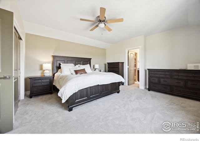 carpeted bedroom featuring a closet, ceiling fan, and vaulted ceiling