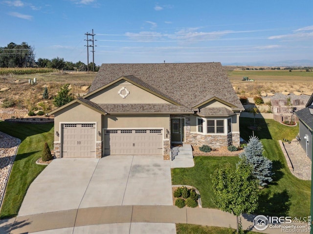 view of front of property featuring a front yard and a garage