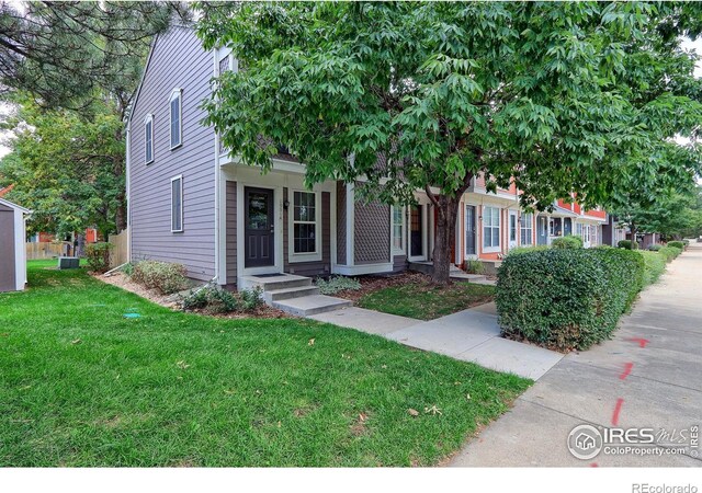 obstructed view of property with a front yard