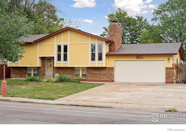 view of front of home with a garage and a front lawn