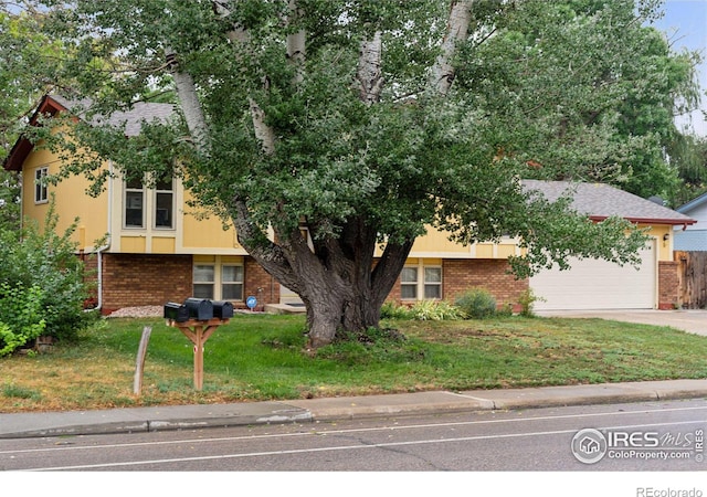 view of front of house with a front lawn and a garage