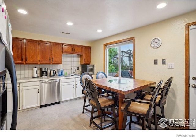 kitchen featuring white cabinetry, appliances with stainless steel finishes, tasteful backsplash, and sink