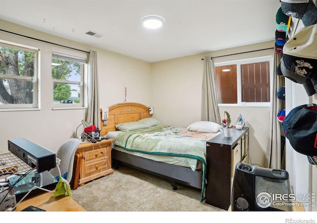 bedroom with light colored carpet