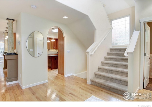 stairway with hardwood / wood-style floors