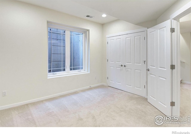 unfurnished bedroom with light carpet