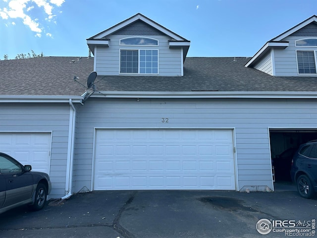 garage featuring aphalt driveway