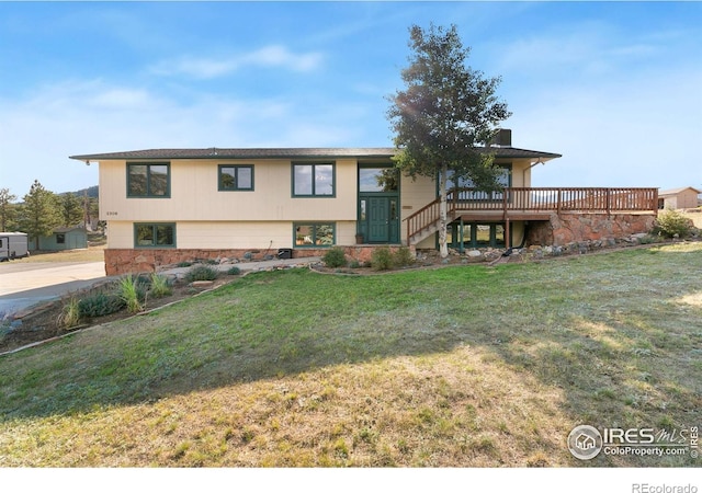 exterior space featuring a deck and a front lawn