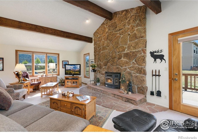 living room featuring vaulted ceiling with beams and a wood stove