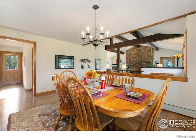 dining area with hardwood / wood-style flooring, a textured ceiling, a notable chandelier, and lofted ceiling with beams