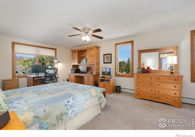 carpeted bedroom with a baseboard radiator, a textured ceiling, and ceiling fan