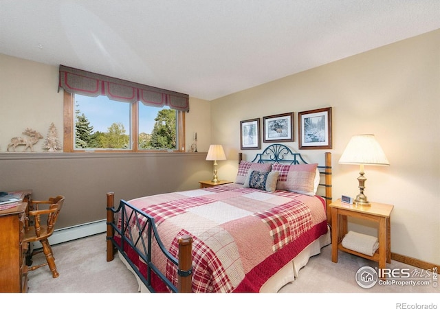 carpeted bedroom featuring baseboard heating