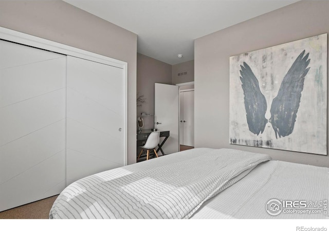 carpeted bedroom with a closet