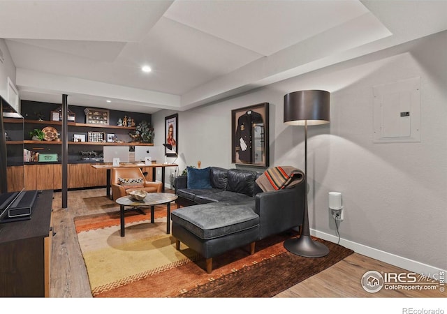 living room featuring wood-type flooring and electric panel