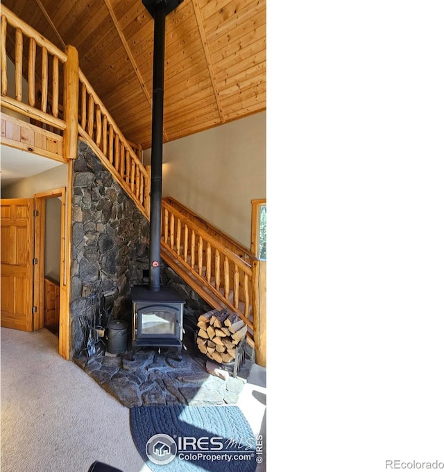 living room featuring a wood stove, high vaulted ceiling, and wood ceiling