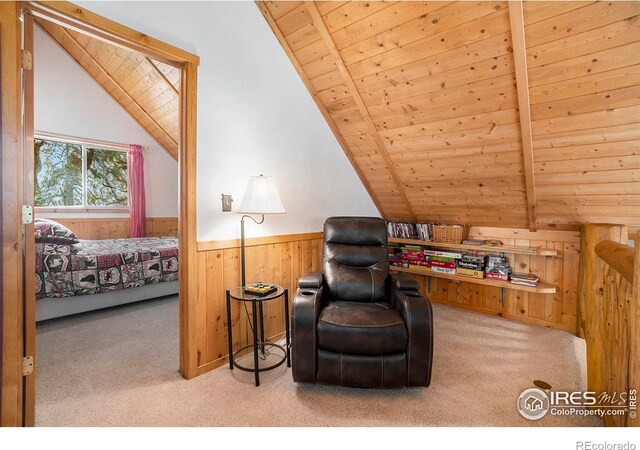 living area with lofted ceiling with beams, light colored carpet, wooden ceiling, and wood walls