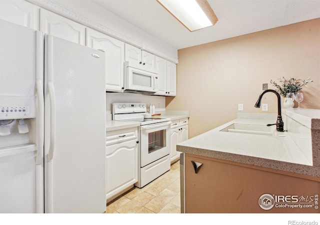 kitchen featuring white cabinets, white appliances, and sink