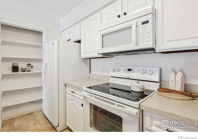 kitchen featuring white cabinetry, white appliances, and light tile patterned floors