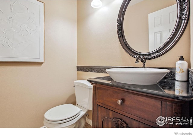 bathroom featuring toilet and vanity