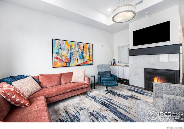 living room with a tile fireplace