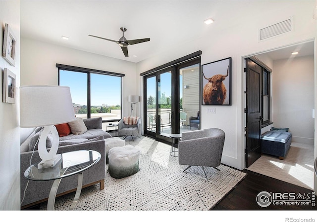 living room with hardwood / wood-style flooring and ceiling fan