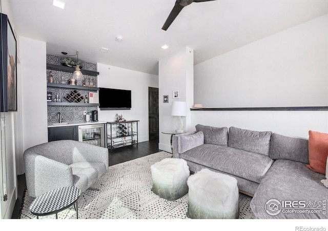 living room featuring wine cooler, indoor wet bar, hardwood / wood-style floors, and ceiling fan