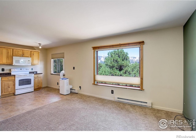 kitchen featuring a baseboard heating unit, white appliances, and plenty of natural light